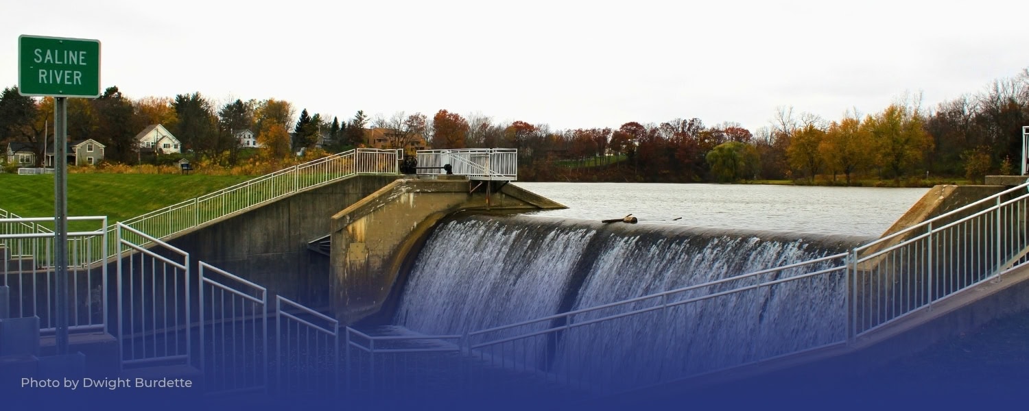 Saline River dam with water flowing over, Michigan climate action.