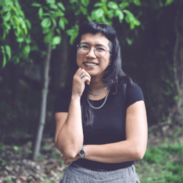 Nancy Morales smiling outdoors in nature.
