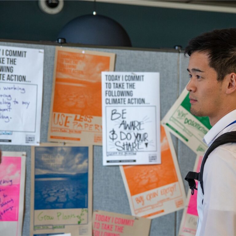 Summit attendee stares at climate poster