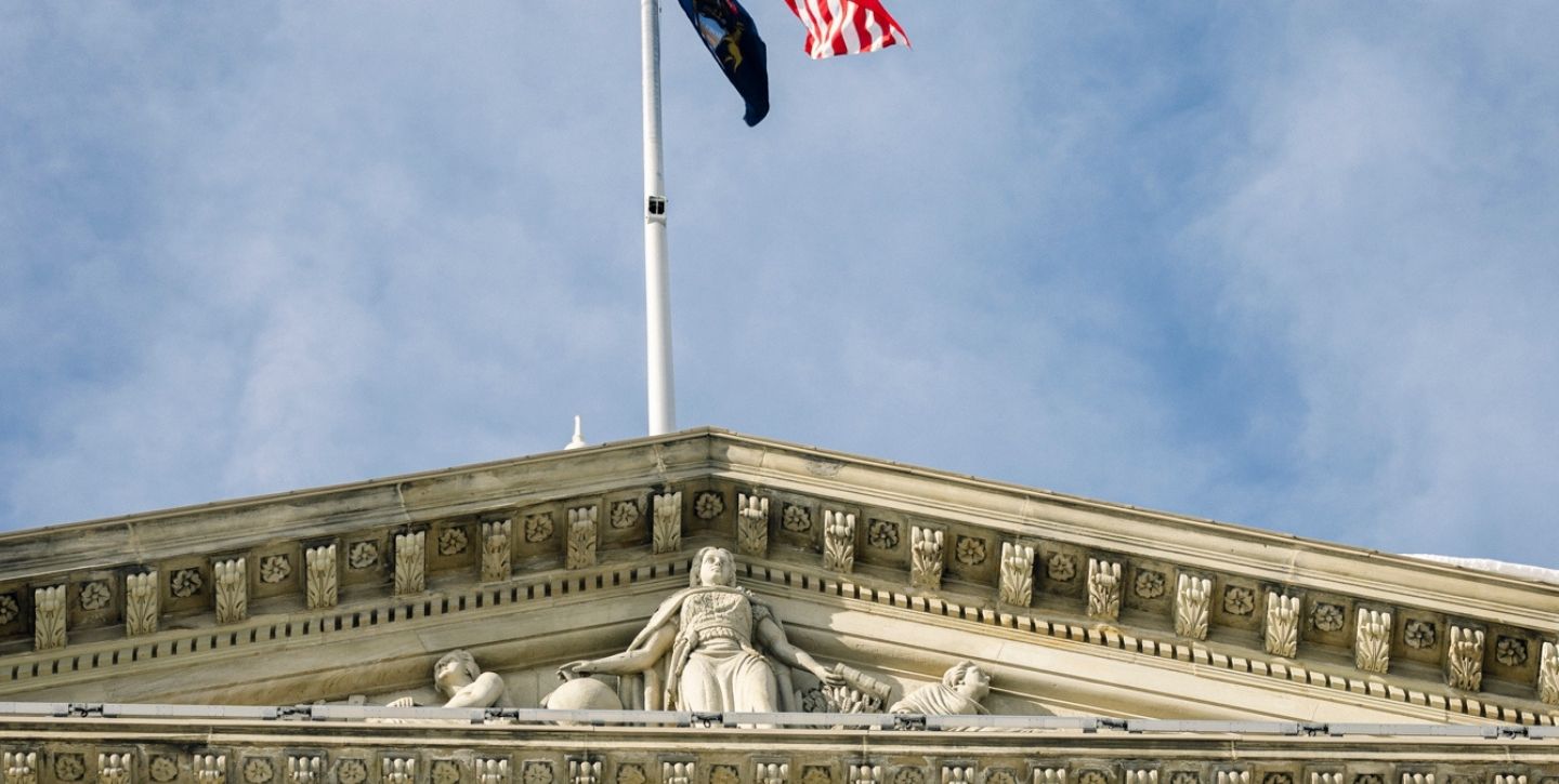 Supreme Court Building with flags and classical architecture.