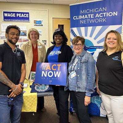 Michigan Climate Action Network logo with people at an event.