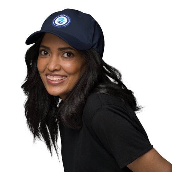 MiCAN Cap logo on navy baseball cap, featuring a circular design with water waves and a blue backgro.