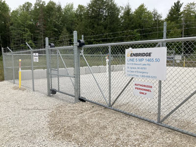 Michigan Climate Action Network logo on a fence gate.