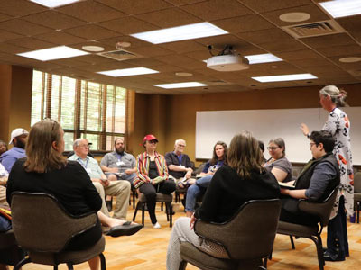 Michigan Climate Action Network logo in a meeting room setting.