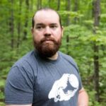 Jerry Jondreau in a forest setting, representing Michigan Climate Action Network efforts to combat climate change.