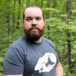 Jerry Jondreau in a forest setting, representing Michigan Climate Action Network efforts to combat climate change.