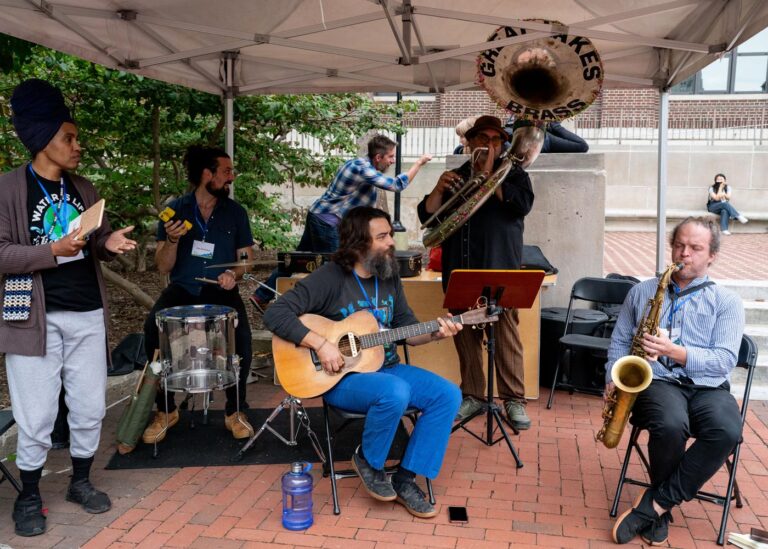 Community jazz musicians playing outdoors in Michigan Climate Action Network event.