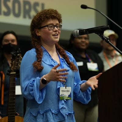 Youth woman speaking at Michigan Climate Action Network conference.