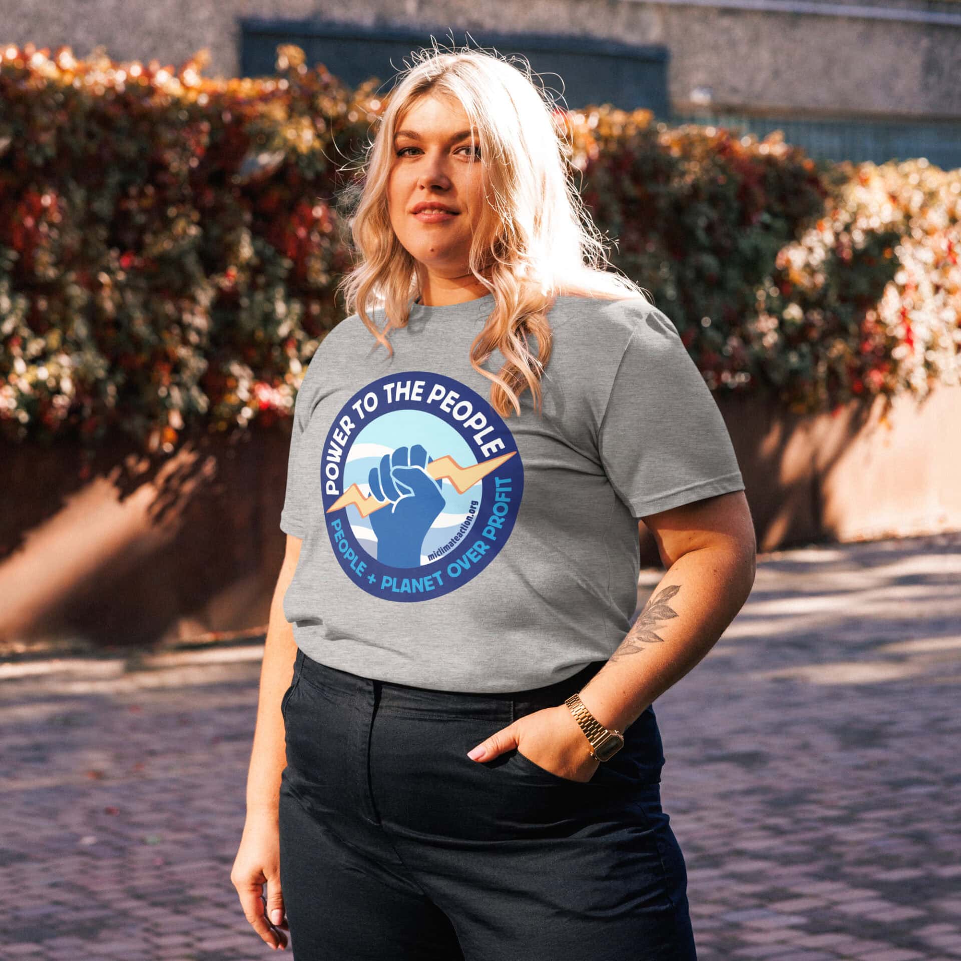 Power to the People T-shirt logo with fist and planet design.